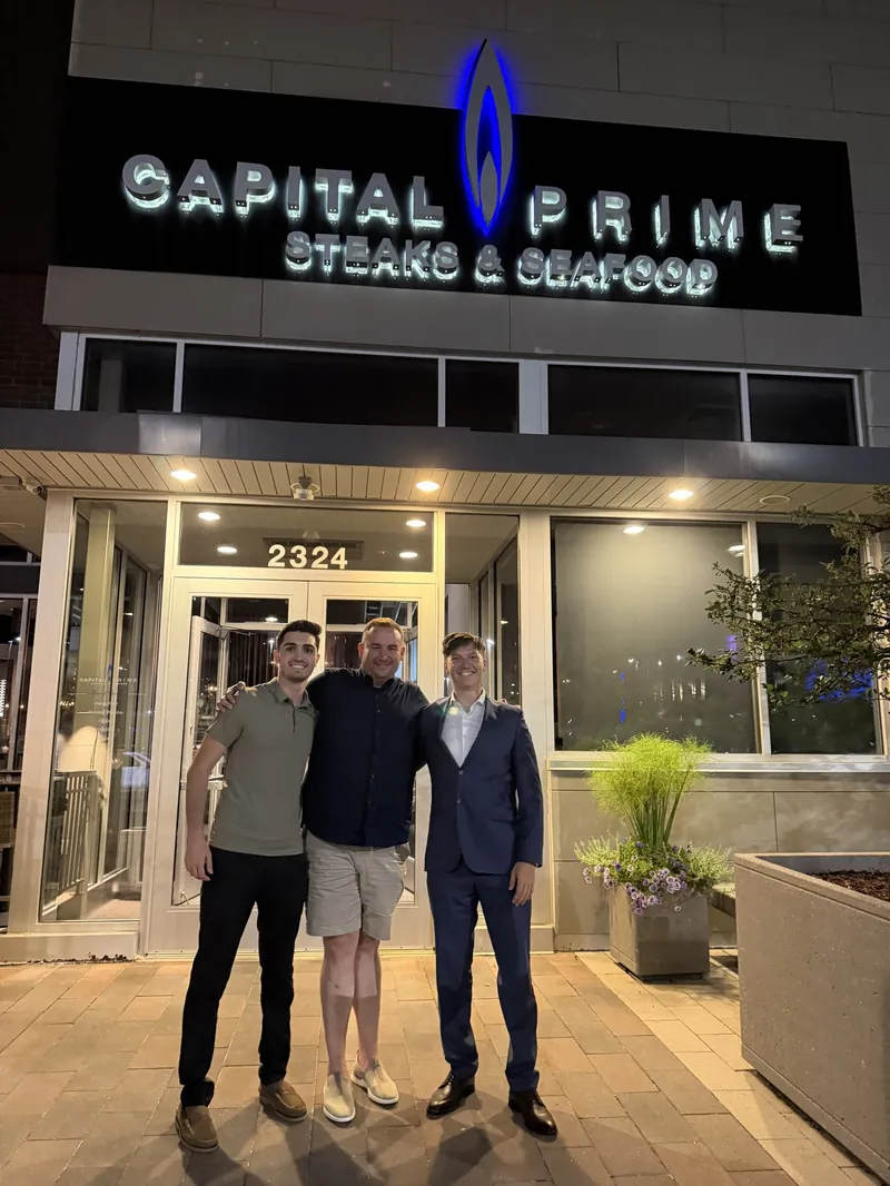 Nick and Ethan with Daniel Benson outside Capital Prime