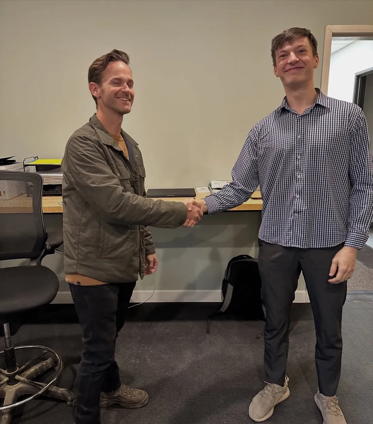 A client handshake at the Modern Apex office after closing a new engagement