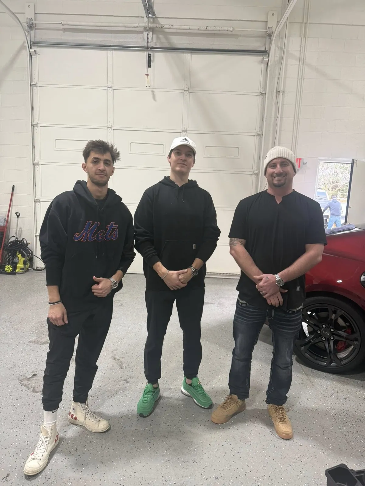 Nick with teammates at a client's auto shop