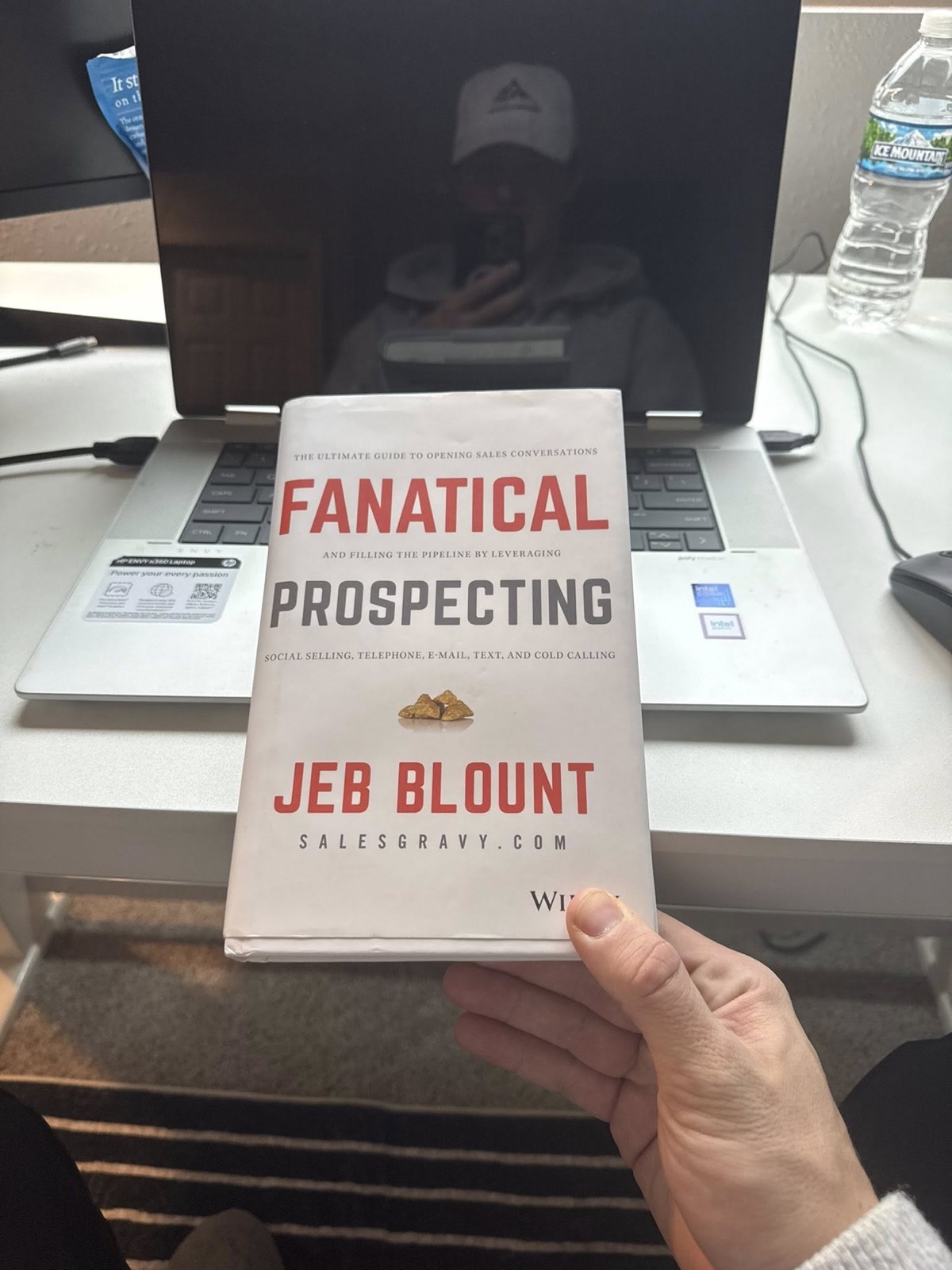 Fanatical Prospecting book by Jeb Blount on Nick's desk