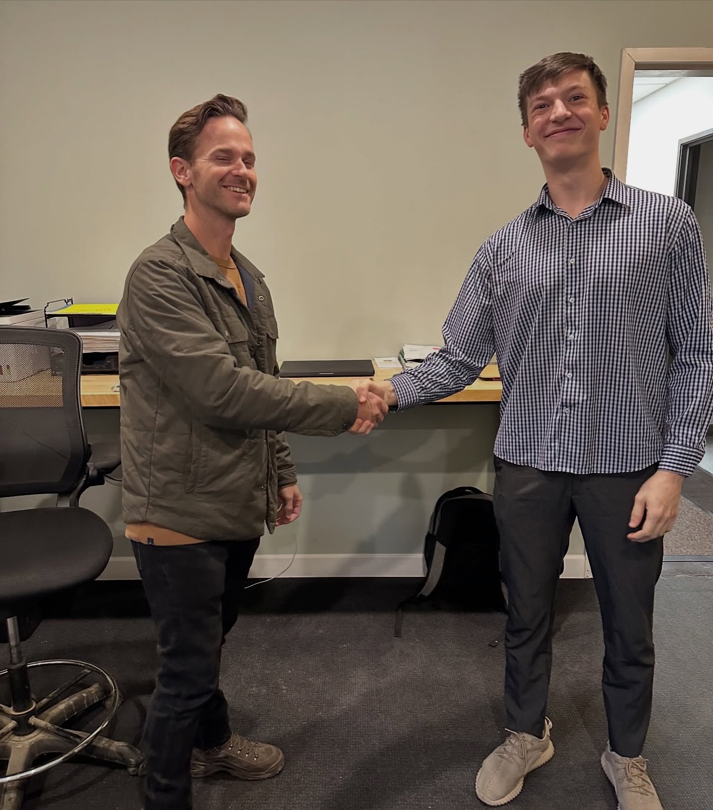 A client handshake at the Modern Apex office after closing a new engagement