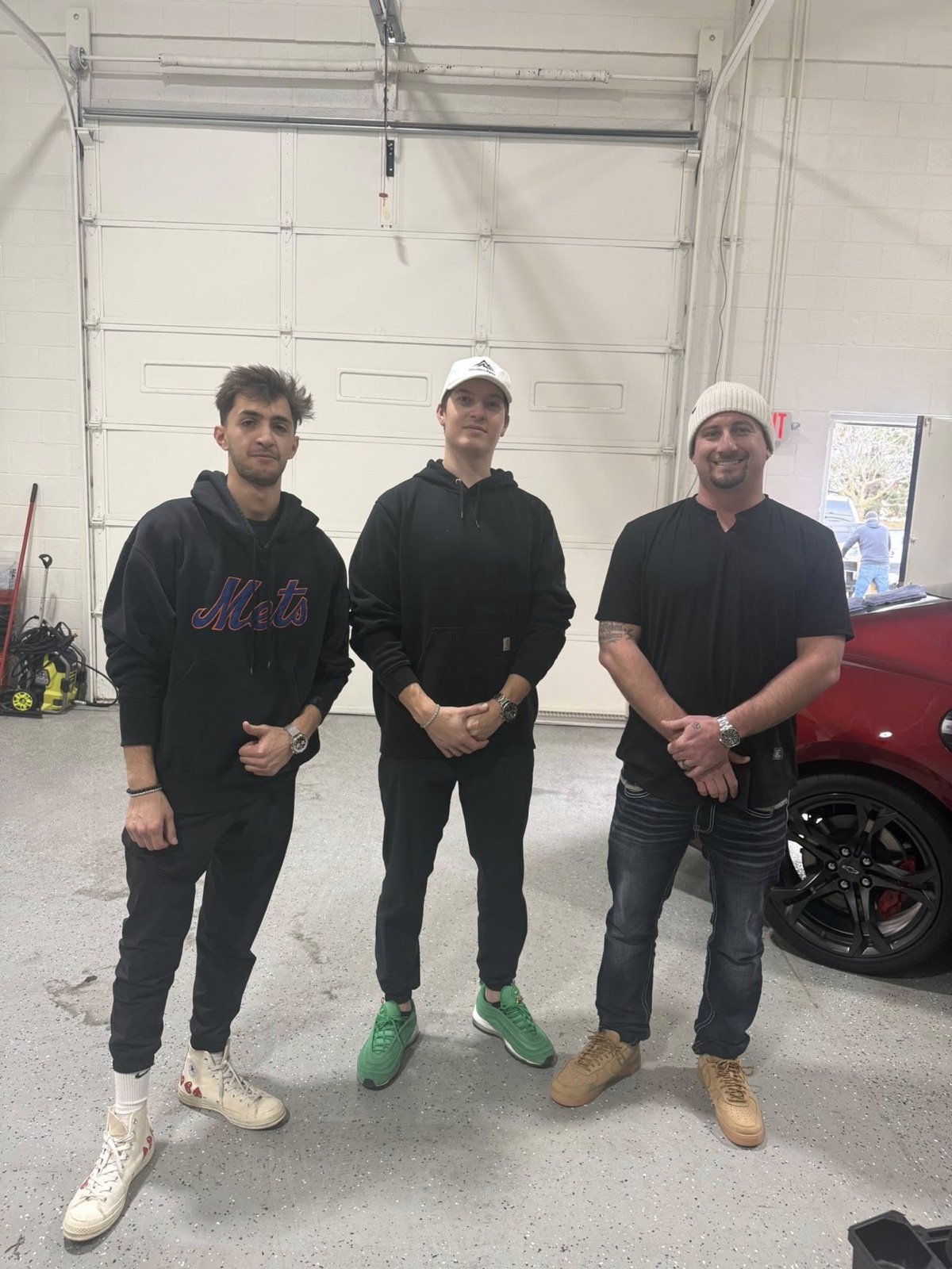 Nick with teammates at a client's auto shop